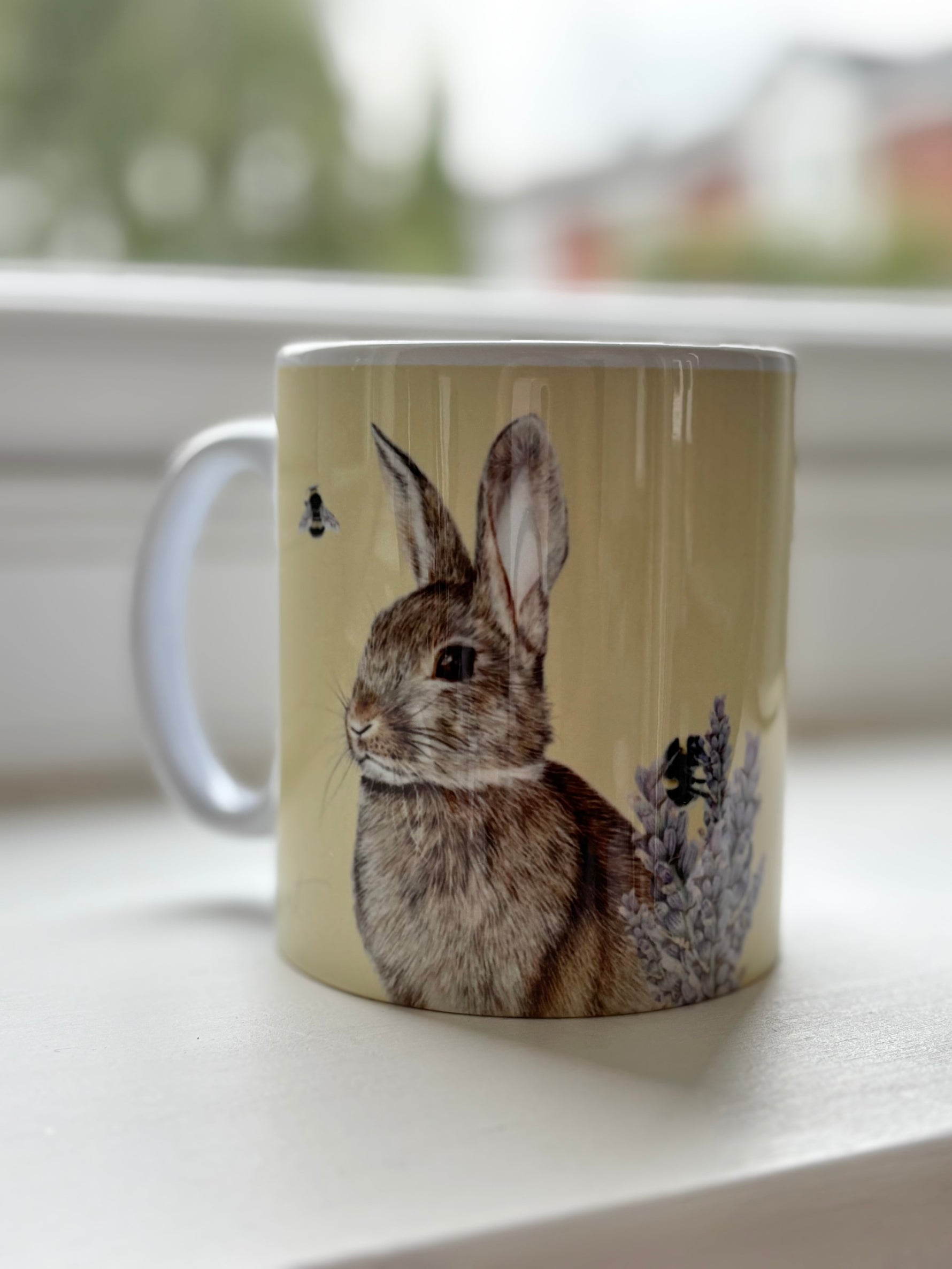 Rabbit Mug featuring hand-drawn British wild rabbit and bees by Georgie Turner. Country kitchenware coffee mug for animal lovers.