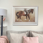 Framed dressage horse original artwork displayed above a sofa in a cozy country-style living room. Ideal large wall art for equestrian home decor.