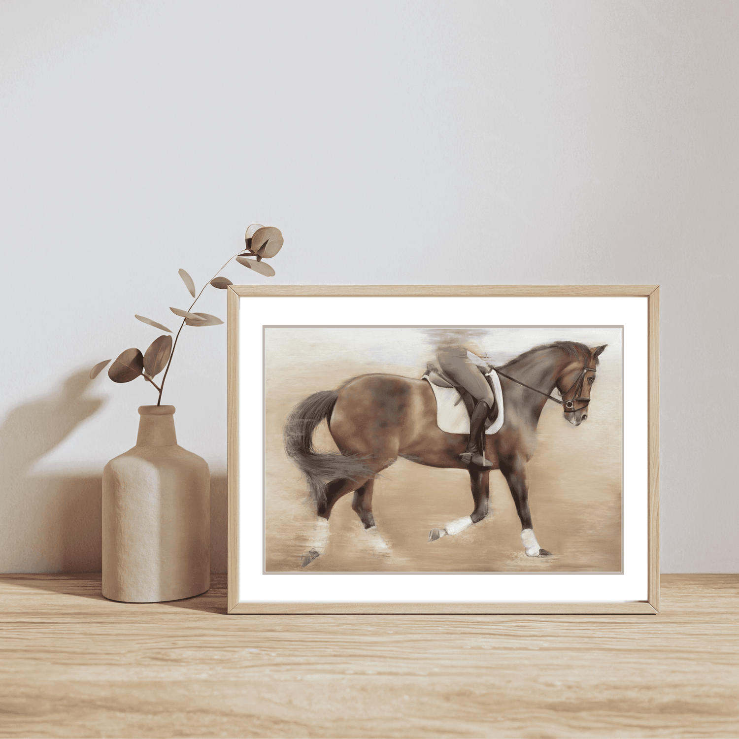 Dressage Training Fine Art Print On Paper featuring a rider training a bay horse, framed and styled on a wooden shelf with a ceramic vase.
