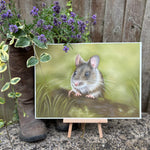 Field Mouse Fine Art Print On Paper displayed outdoors on a mini easel beside rustic boots and lavender, ideal for British countryside home decor.