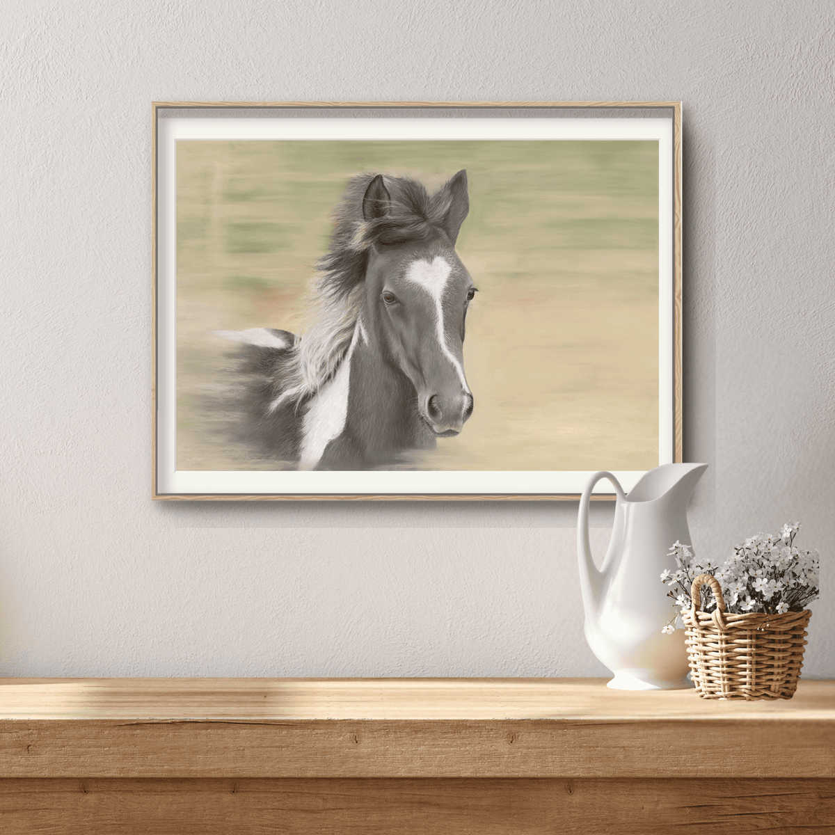 Framed Galloping Foal Fine Art Print by Georgie Turner on a rustic console table, perfect for adding equestrian charm to home interiors.