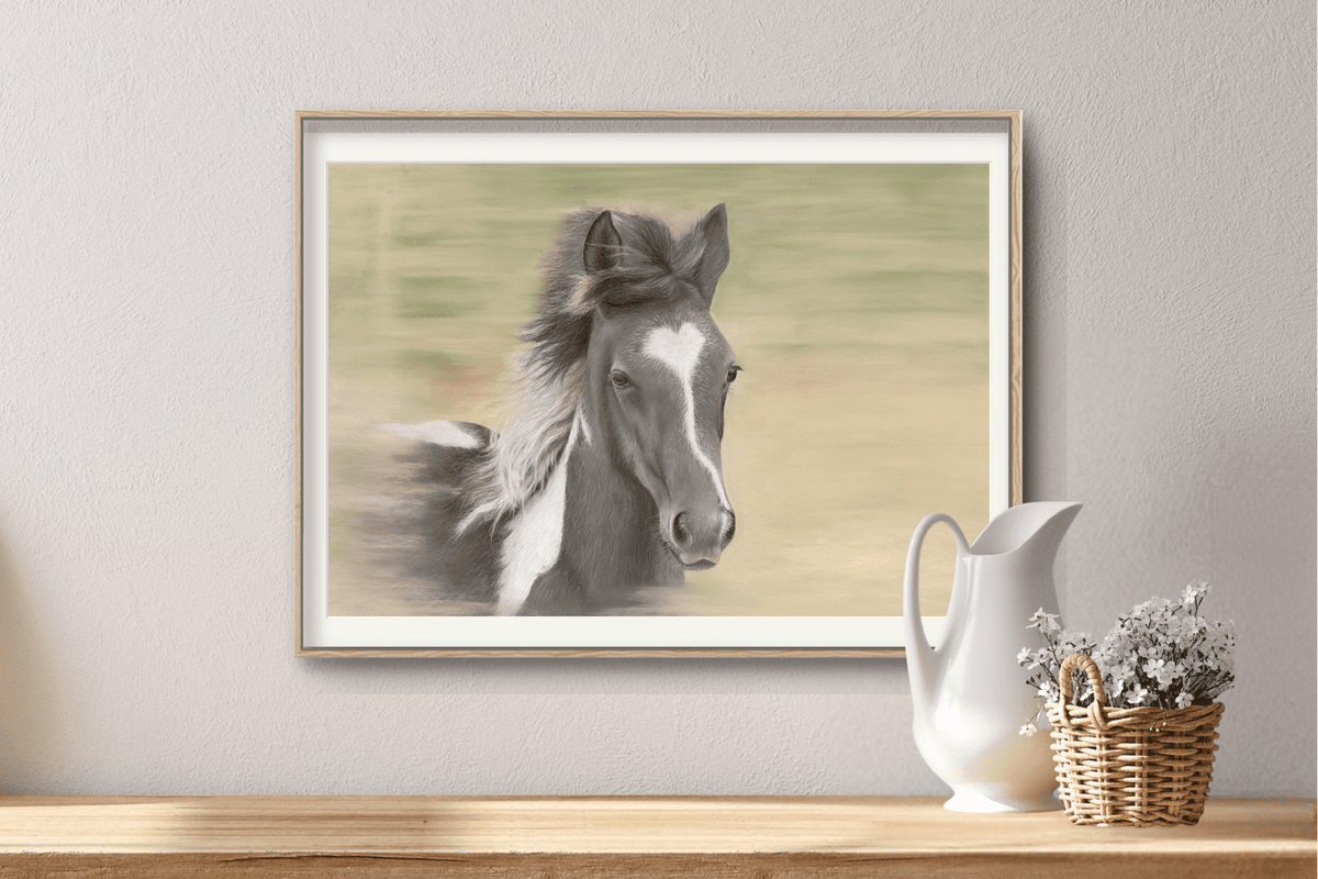 Equestrian Galloping Foal Fine Art Print in a modern frame, styled with a wicker basket and ceramic pitcher for cozy home decor appeal.