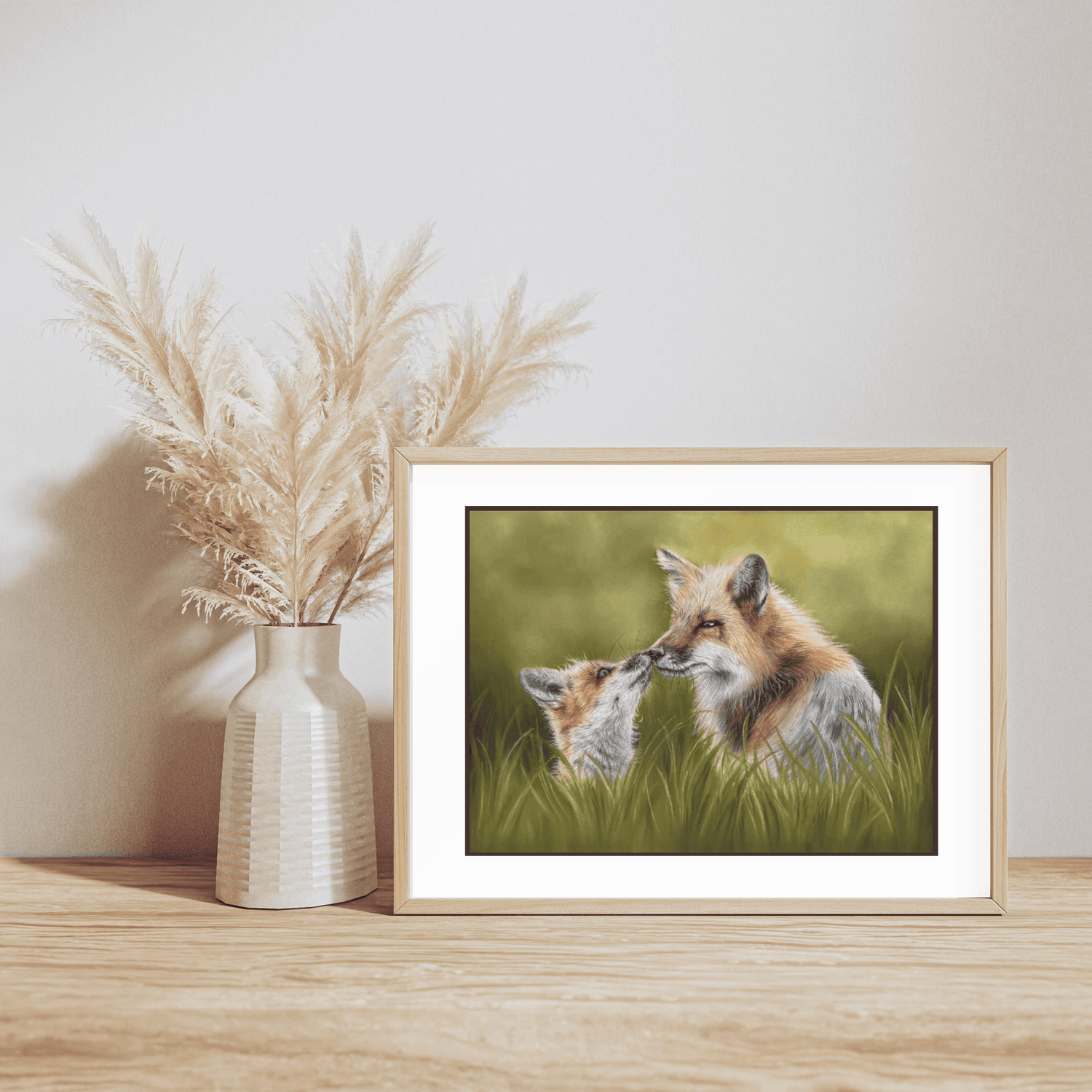 Framed Fox & Cub Fine Art Print On Paper displayed on wooden shelf with pampas grass vase, ideal for British countryside home decor.