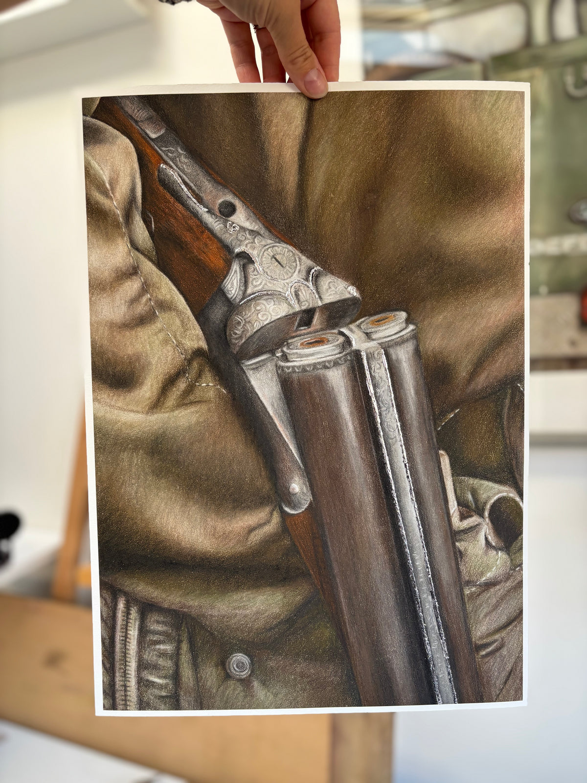 Unframed Country Shoot Fine Art Print held by hand, highlighting realistic detail of double-barrel shotgun and field sport clothing.