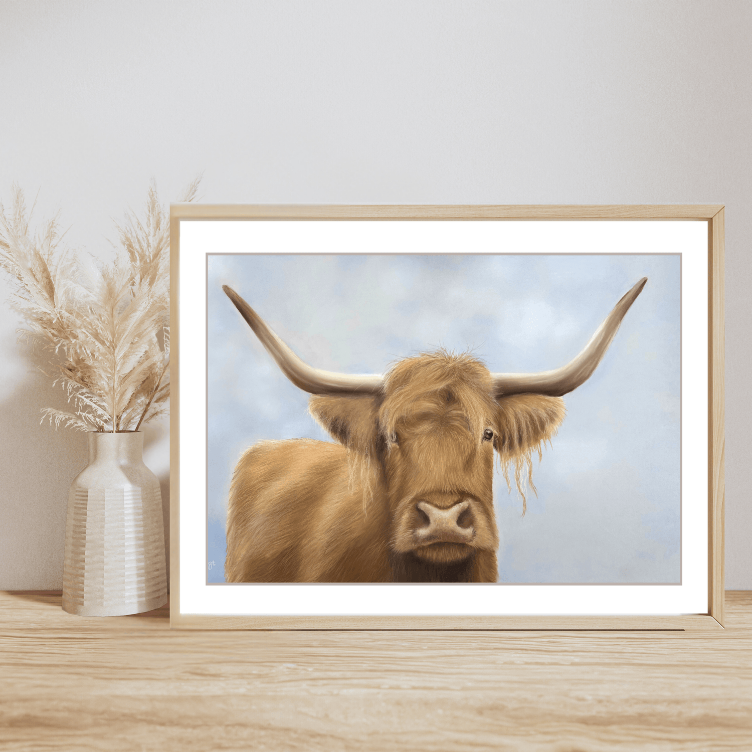 Scottish Highland Cow Print fine art giclee in wooden frame on wooden shelf with pampas grass vase. Ideal farming wall print for rustic home decor.
