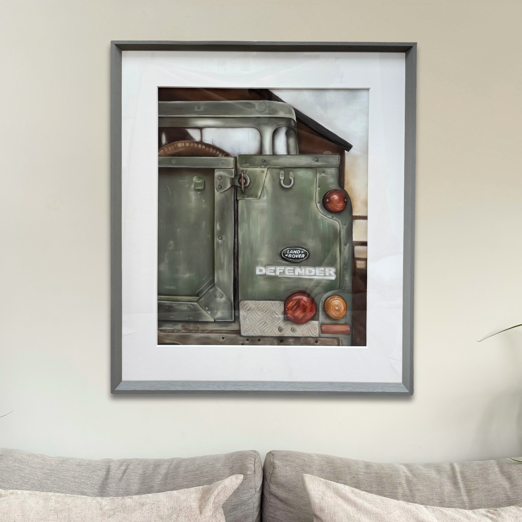 Framed Landrover Defender original artwork displayed above a sofa, ideal for country home decor and large wall art settings.