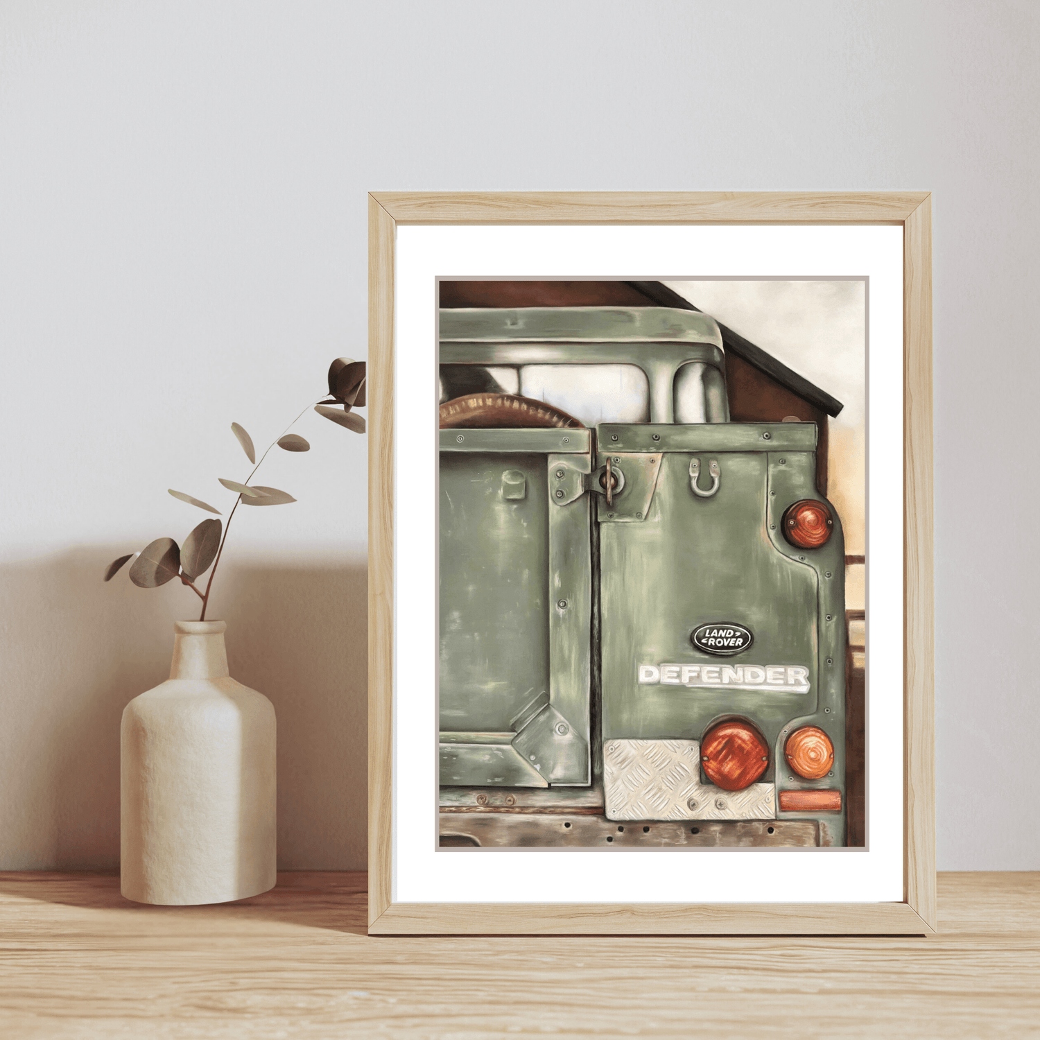 Landrover Print - Art Print | British Classic, Limited Edition in a light wood frame on a wooden surface with a ceramic vase. Perfect for rustic home decor.