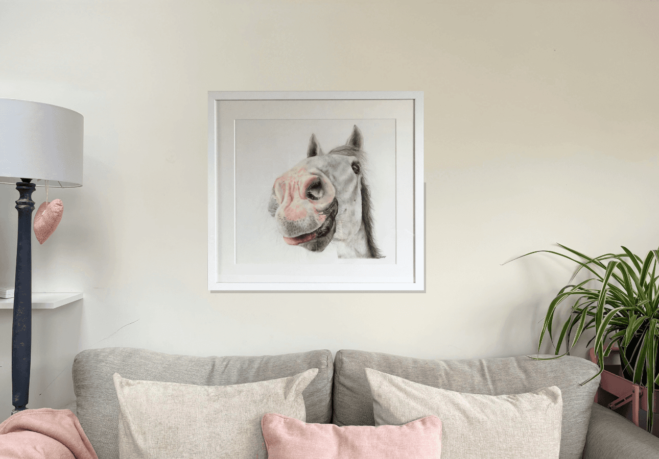 Equestrian-themed framed painting 'Nosy Pony' by Georgie Turner, hung in a cozy living room with neutral tones. Perfect pony wall art for rustic interiors.