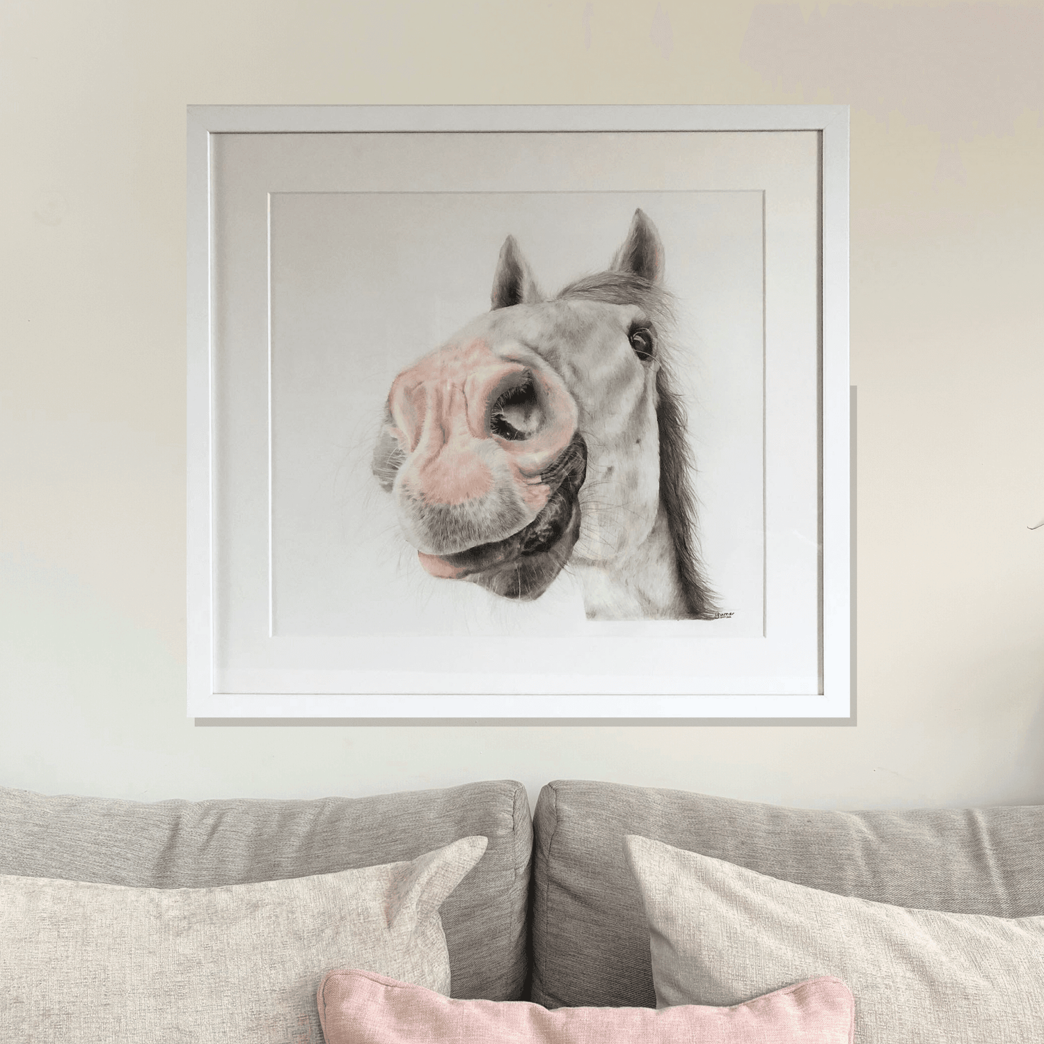 Framed pony original artwork titled 'Nosy Pony' by Georgie Turner, displayed above a beige sofa. Ideal for country home decor and equestrian art lovers.