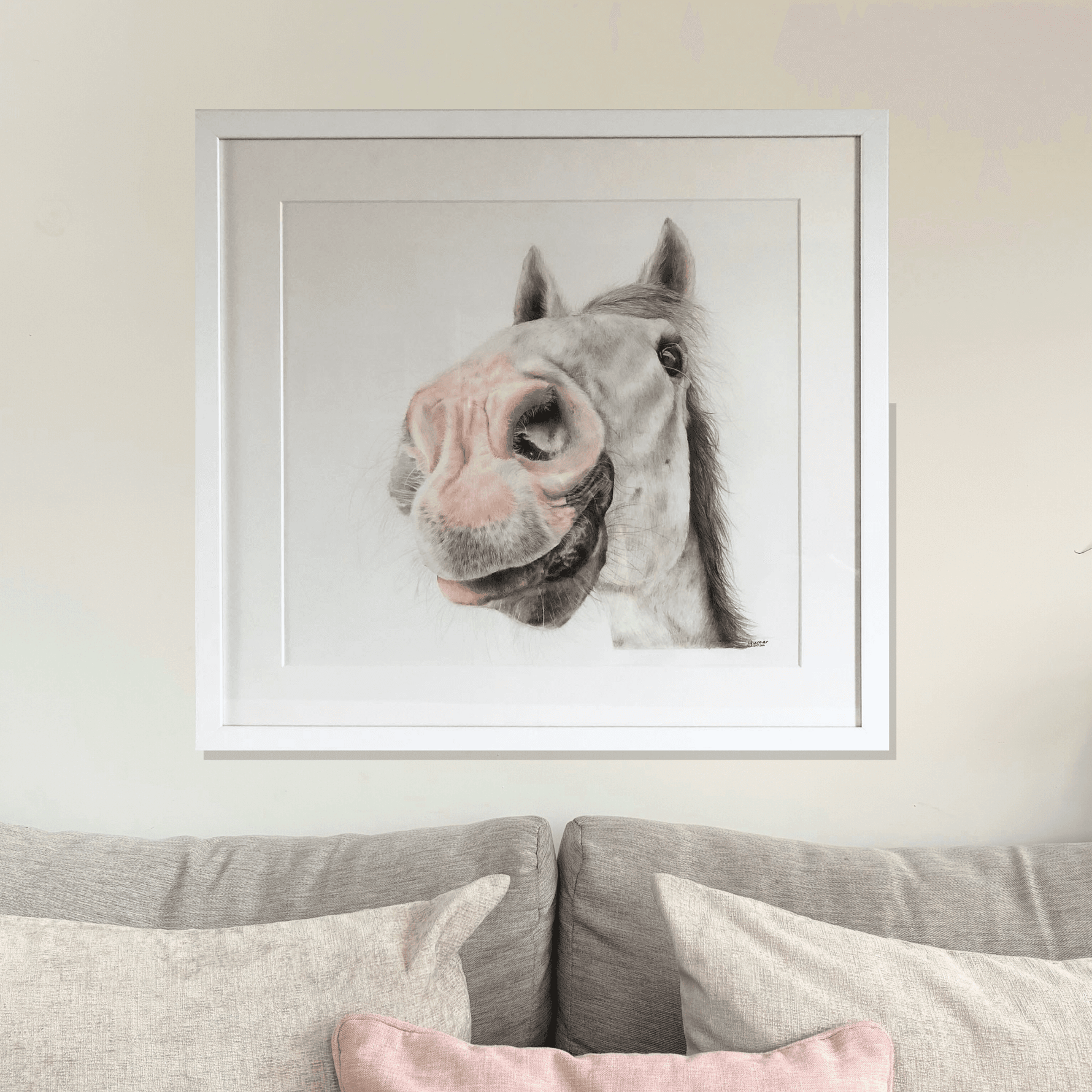 Framed pony original artwork titled 'Nosy Pony' by Georgie Turner, displayed above a beige sofa. Ideal for country home decor and equestrian art lovers.