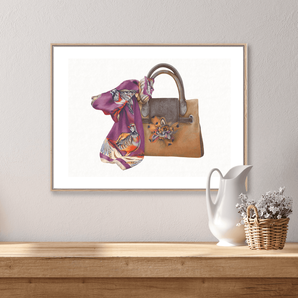 Framed Bag & Scarf Fine Art Print on Paper with Fairfax and Favor style, displayed above a rustic console with wicker basket and ceramic pitcher.