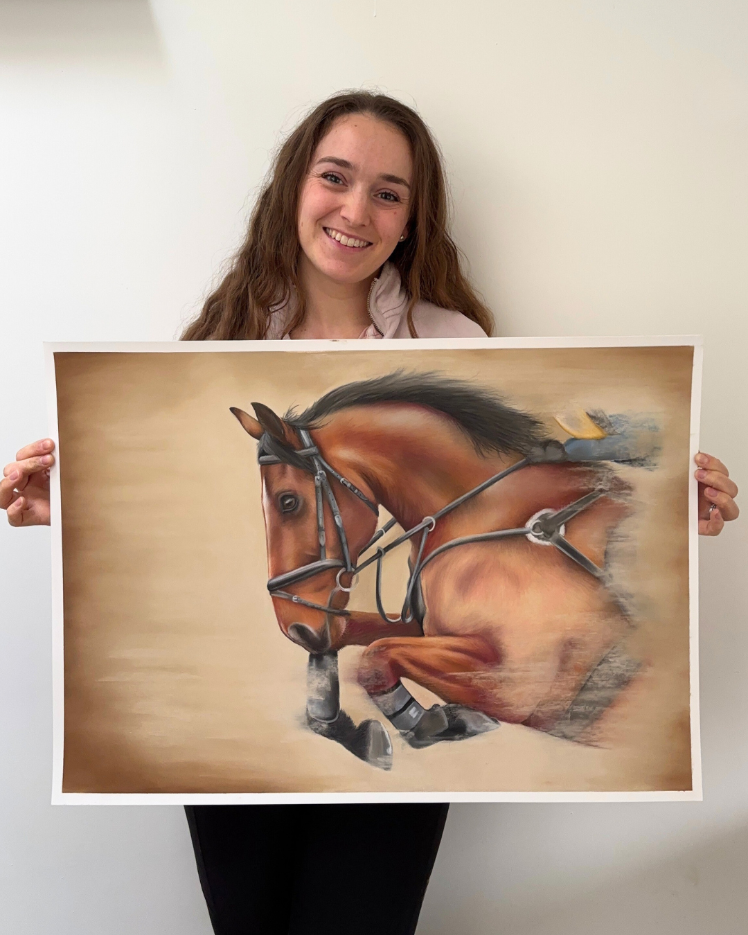 Woman holding 'Flying Forward' showjumping horse original painting, showcasing large equestrian wall art for country home decor.