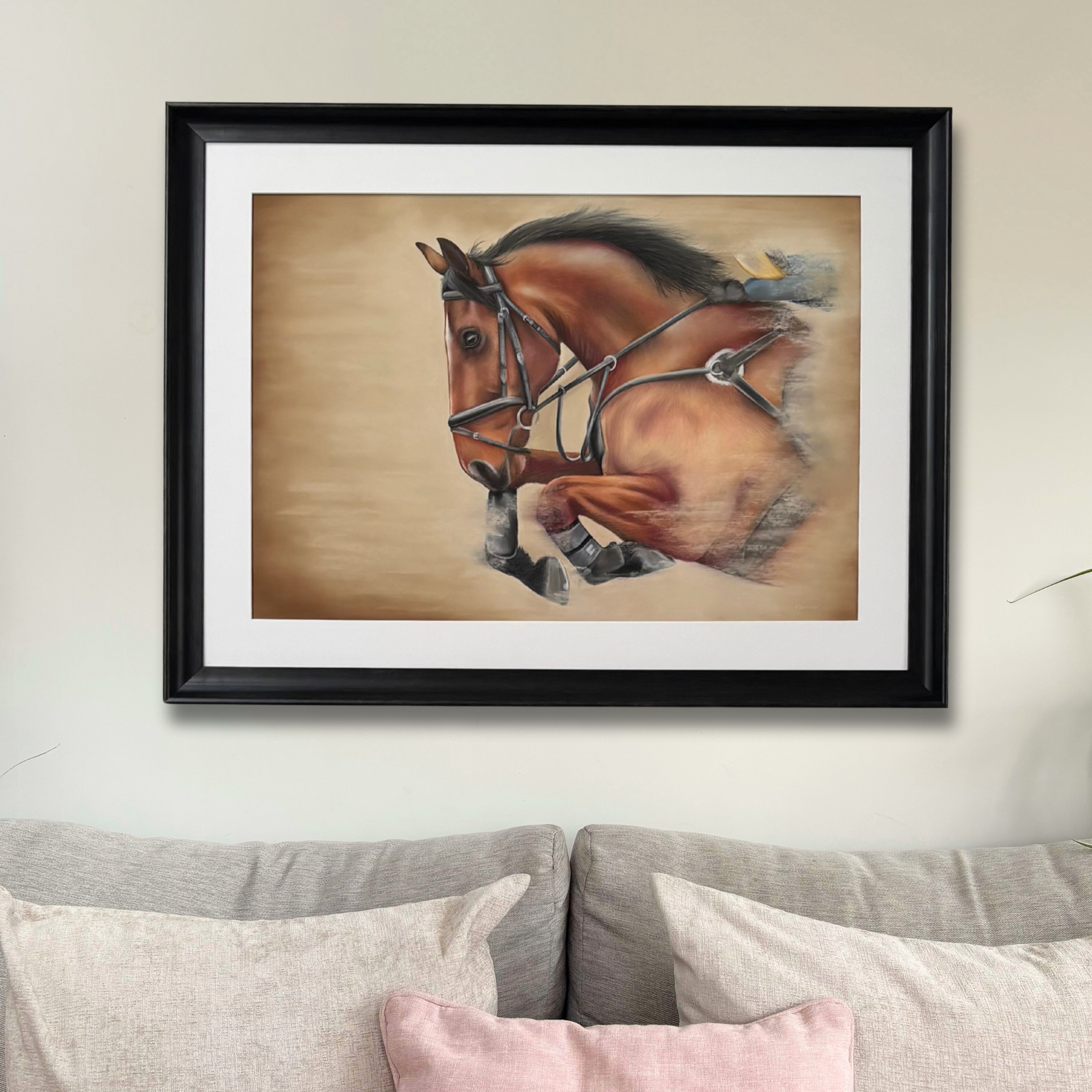 Showjumping horse original artwork in black frame above sofa, ideal for country home decor and large wall art in equestrian-themed interiors.
