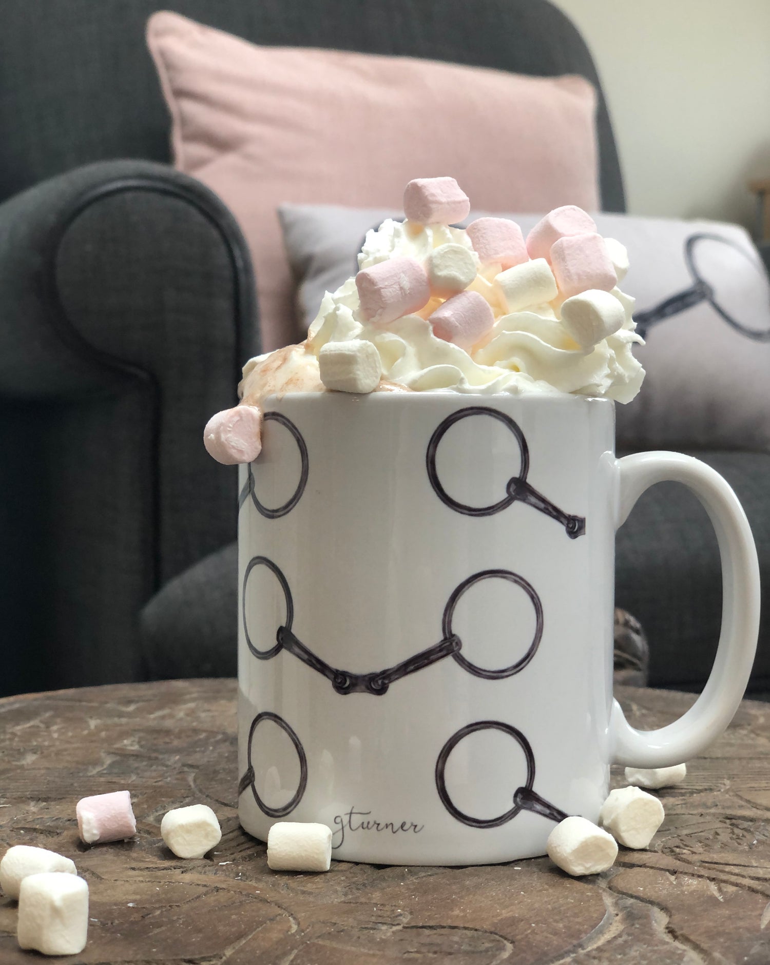 Snaffle Mug - Country Kitchenware filled with whipped cream and marshmallows, ideal gift for horse lovers, set in a cozy living room setting.