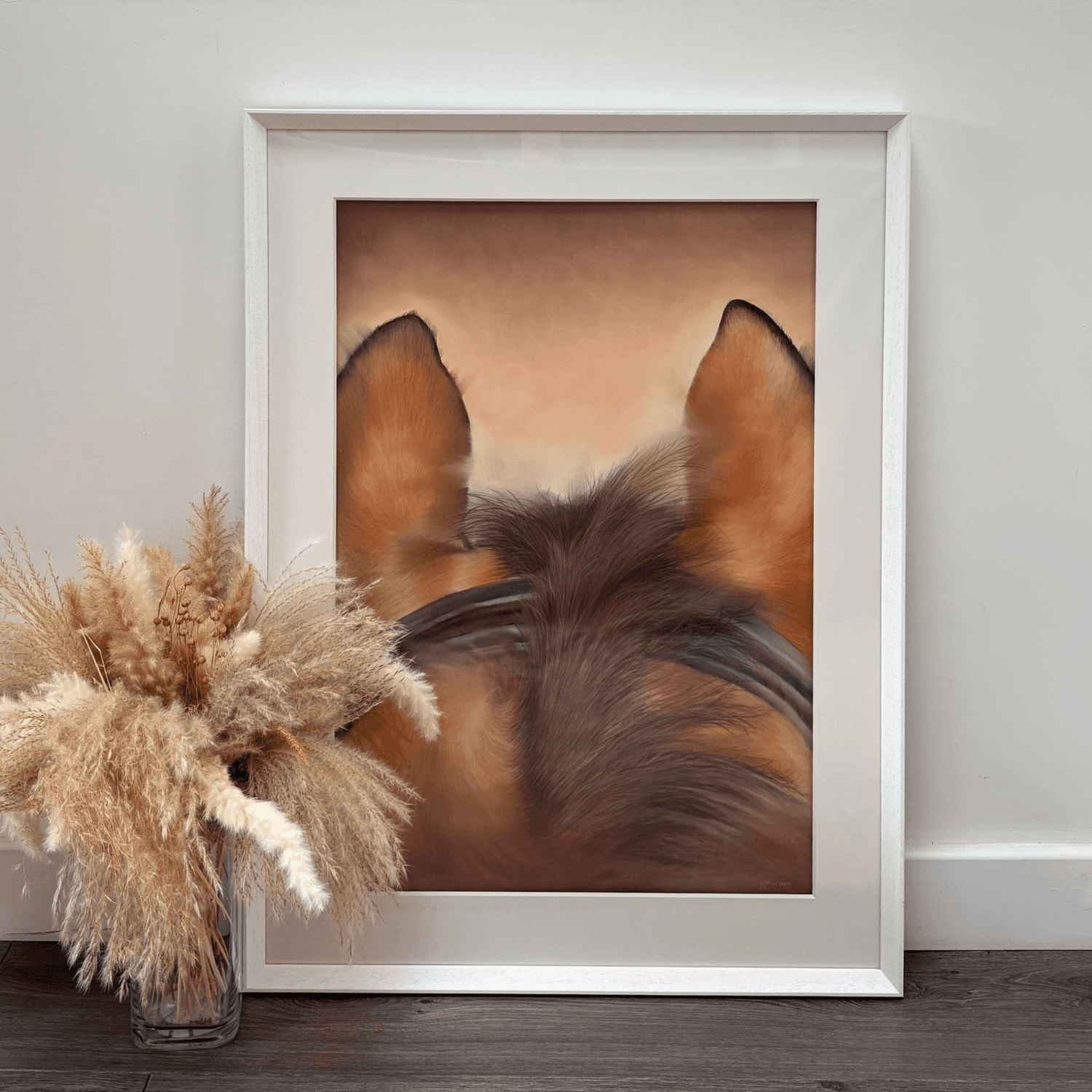 Framed horse riding original painting 'Through The Ears' leaning against a wall with pampas grass, perfect for rustic country home decor.