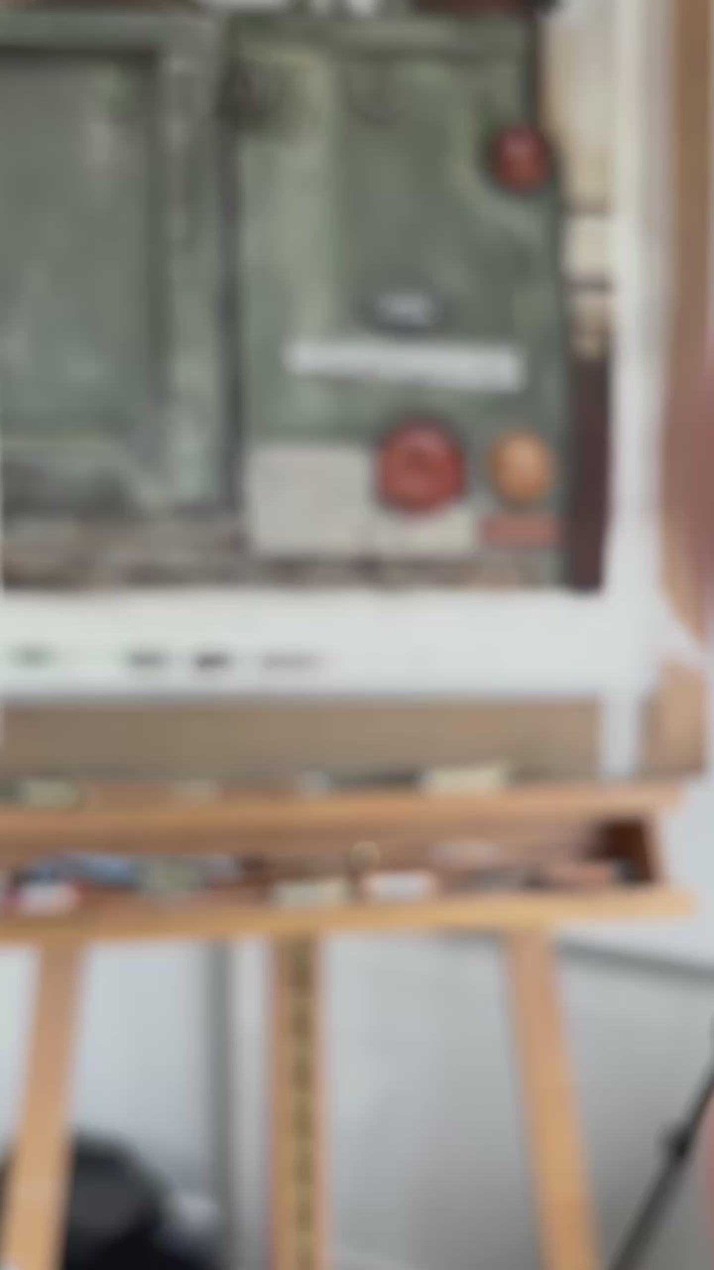 Blurry view of Landrover Defender artwork on easel, emphasizing original painting style for country home wall decor.