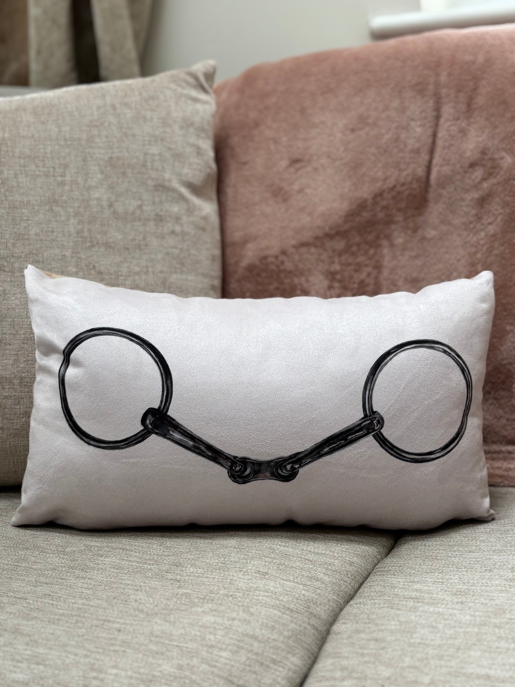 Snaffle Cushion featuring a black snaffle bit illustration on a cream background. Ideal equestrian decor for country home living rooms.