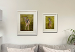 Framed 'Hare In The Grass' and deer artworks by Georgie Turner on living room wall. Country home decor with wildlife-themed original paintings.