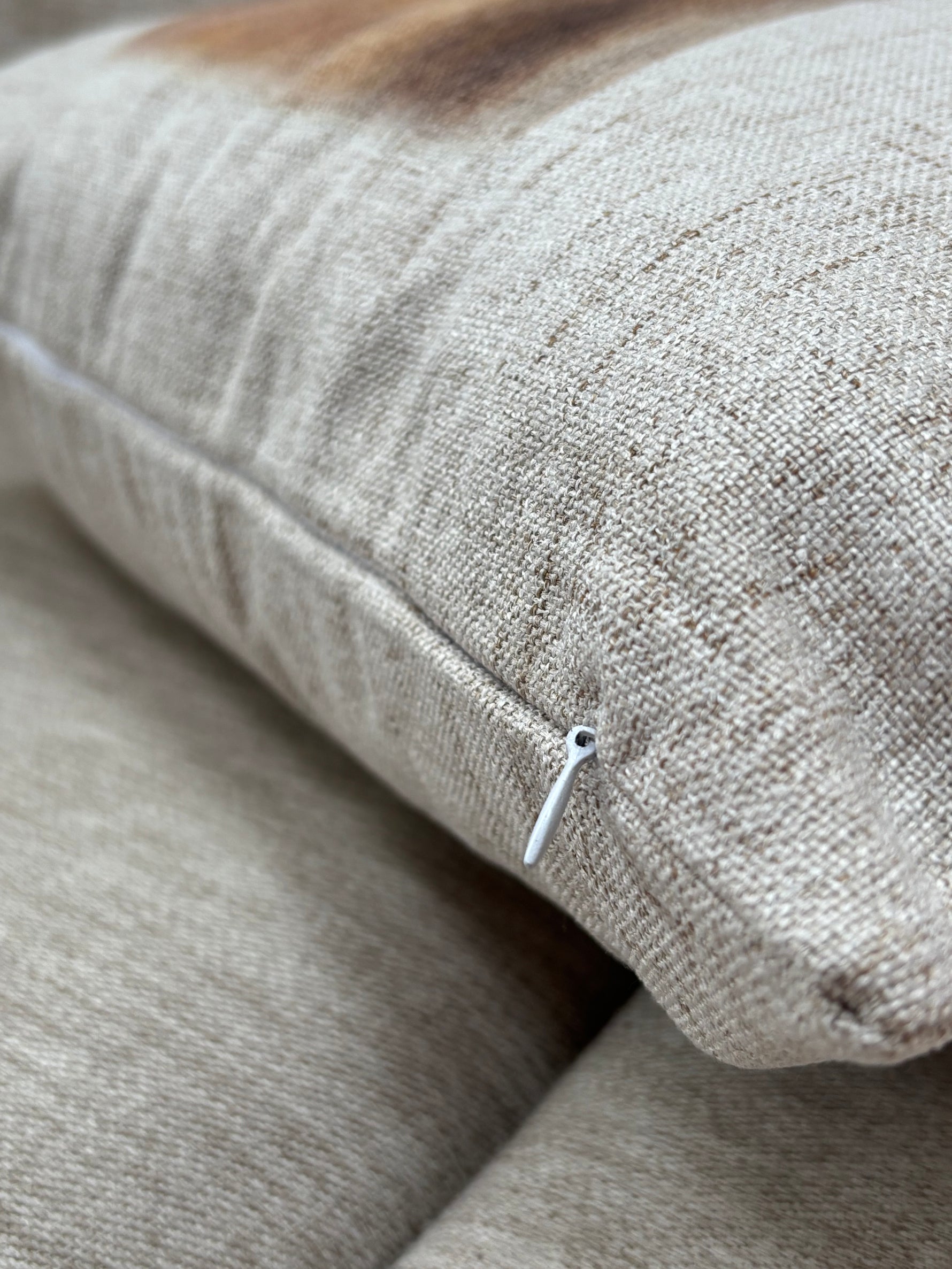 Back view of custom cushion, natural-toned fabric and hidden zipper, designed for rustic and country-themed interiors.