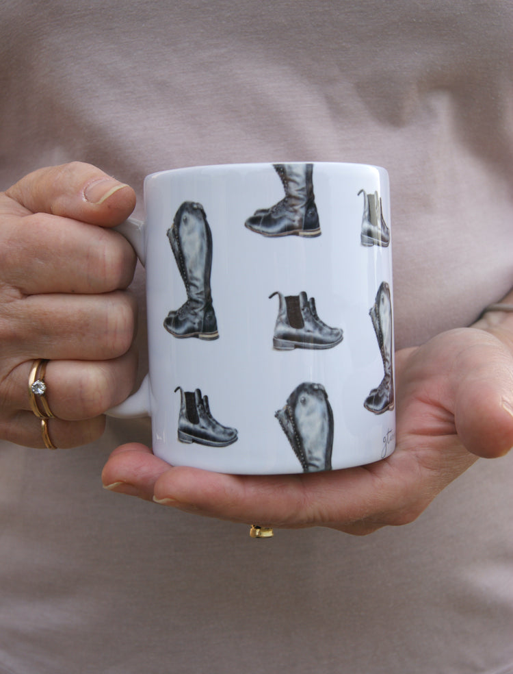 Women holding riding boot mug 