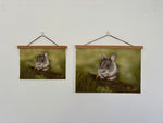 Two sizes of Field Mouse Fine Art Print On Paper hanging on a white wall with wooden hangers, perfect for British countryside-inspired interiors.