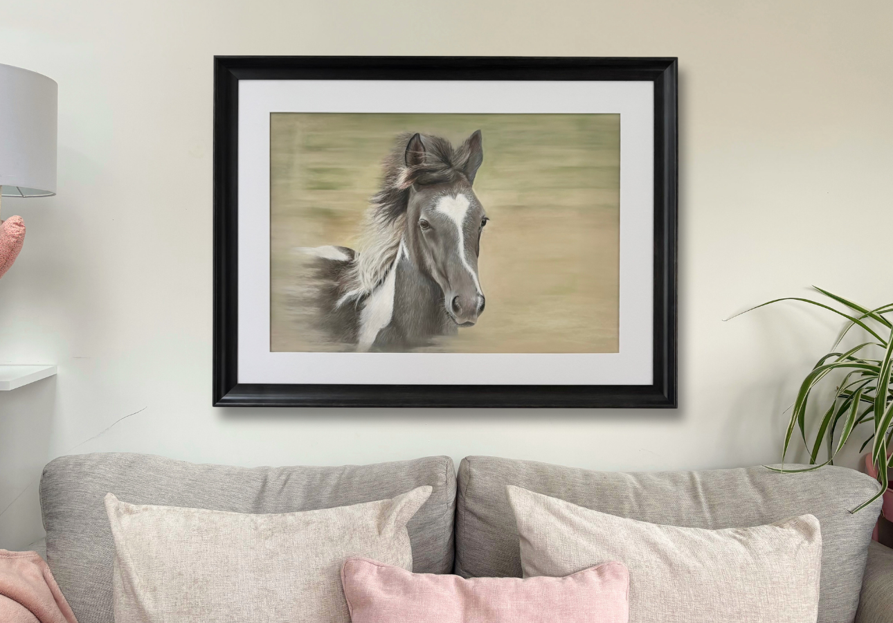 Large wall art of a foal titled 'Flying Free' in a black frame, styled in a cozy living room for country home decor inspiration.