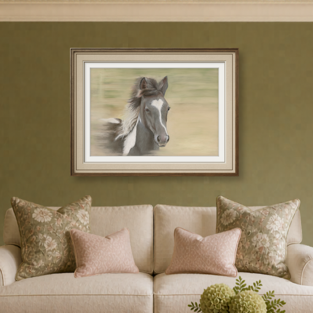 Framed artwork of a horse on a wall above a beige sofa with decorative pillows and a wooden coffee table.