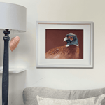 Framed pheasant wall art 'Gerald' hanging in a cozy living room, perfect for rustic and equestrian-inspired country home decor.