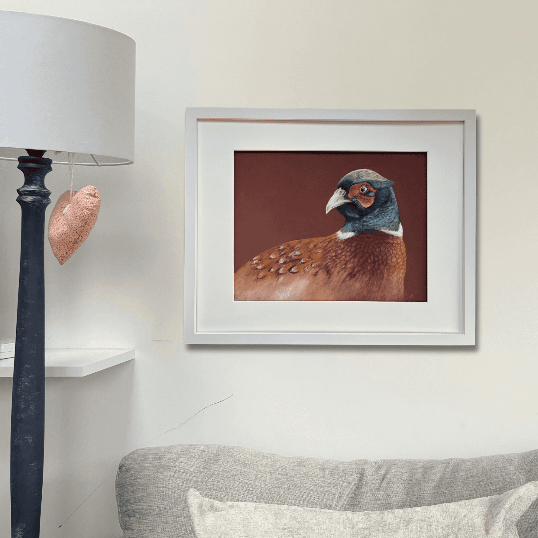 Framed pheasant wall art 'Gerald' hanging in a cozy living room, perfect for rustic and equestrian-inspired country home decor.