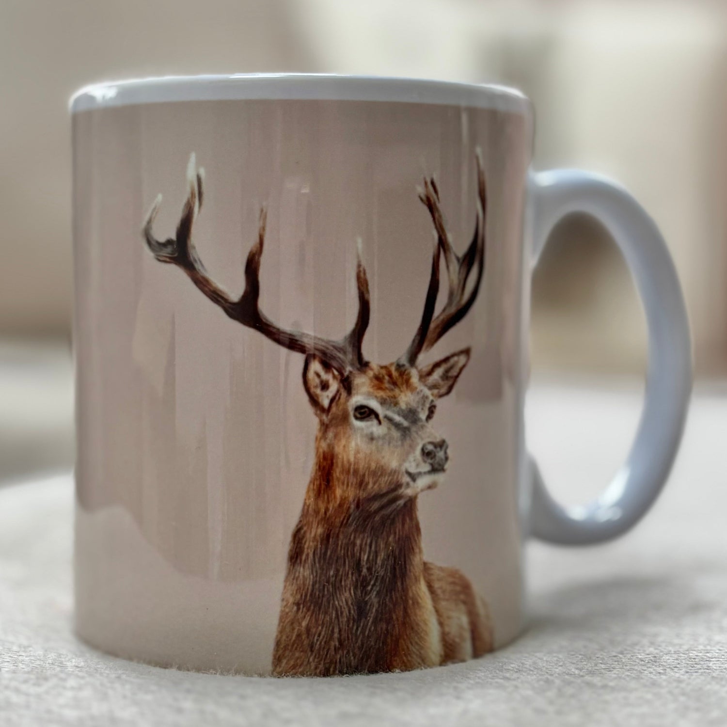 Mug with a deer design on a light surface