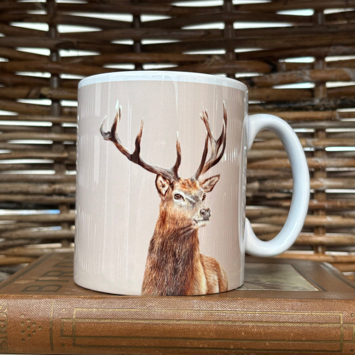 Mug with a deer design on a wooden surface