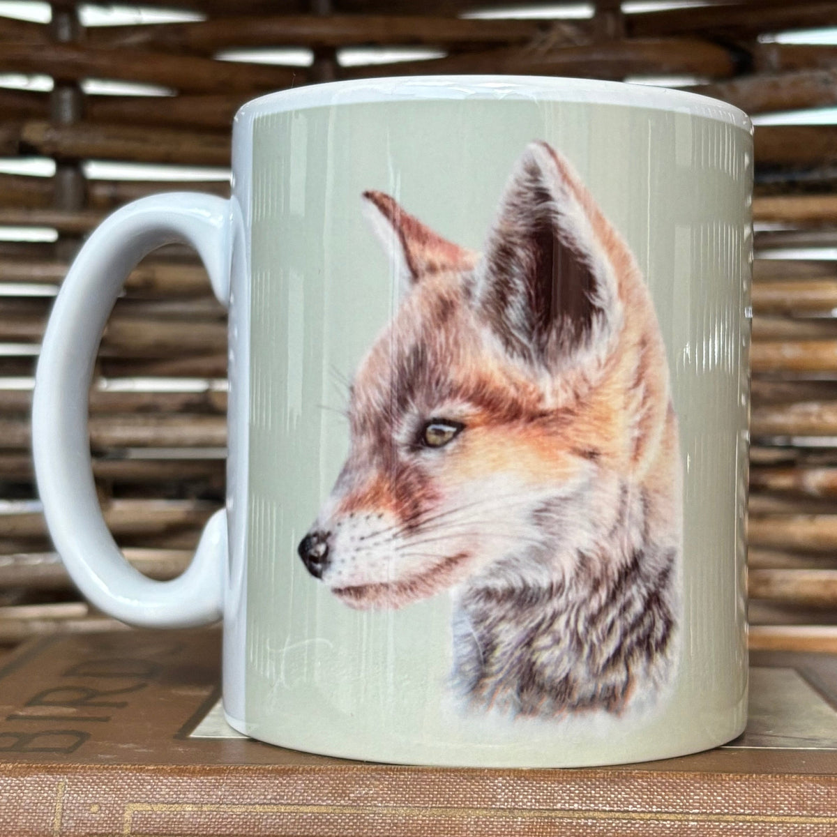 Mug with a fox design on a wooden surface
