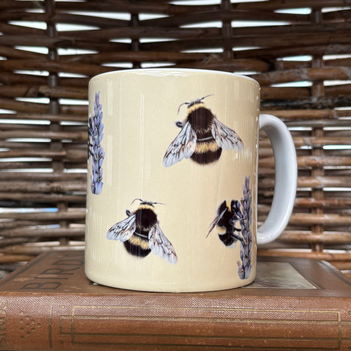 Mug with bee design on a wooden surface
