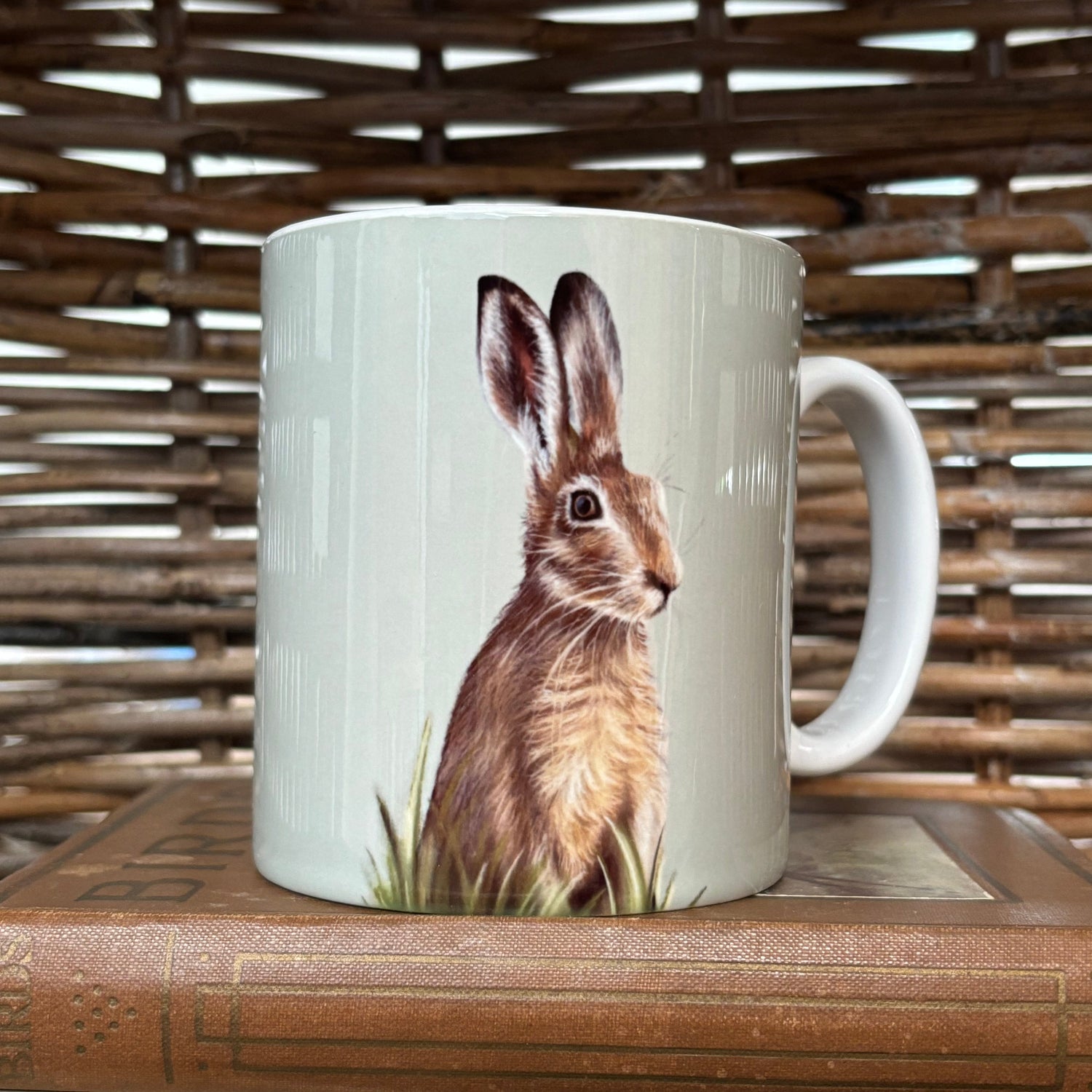 Mug with a rabbit design hanging on a wooden surface