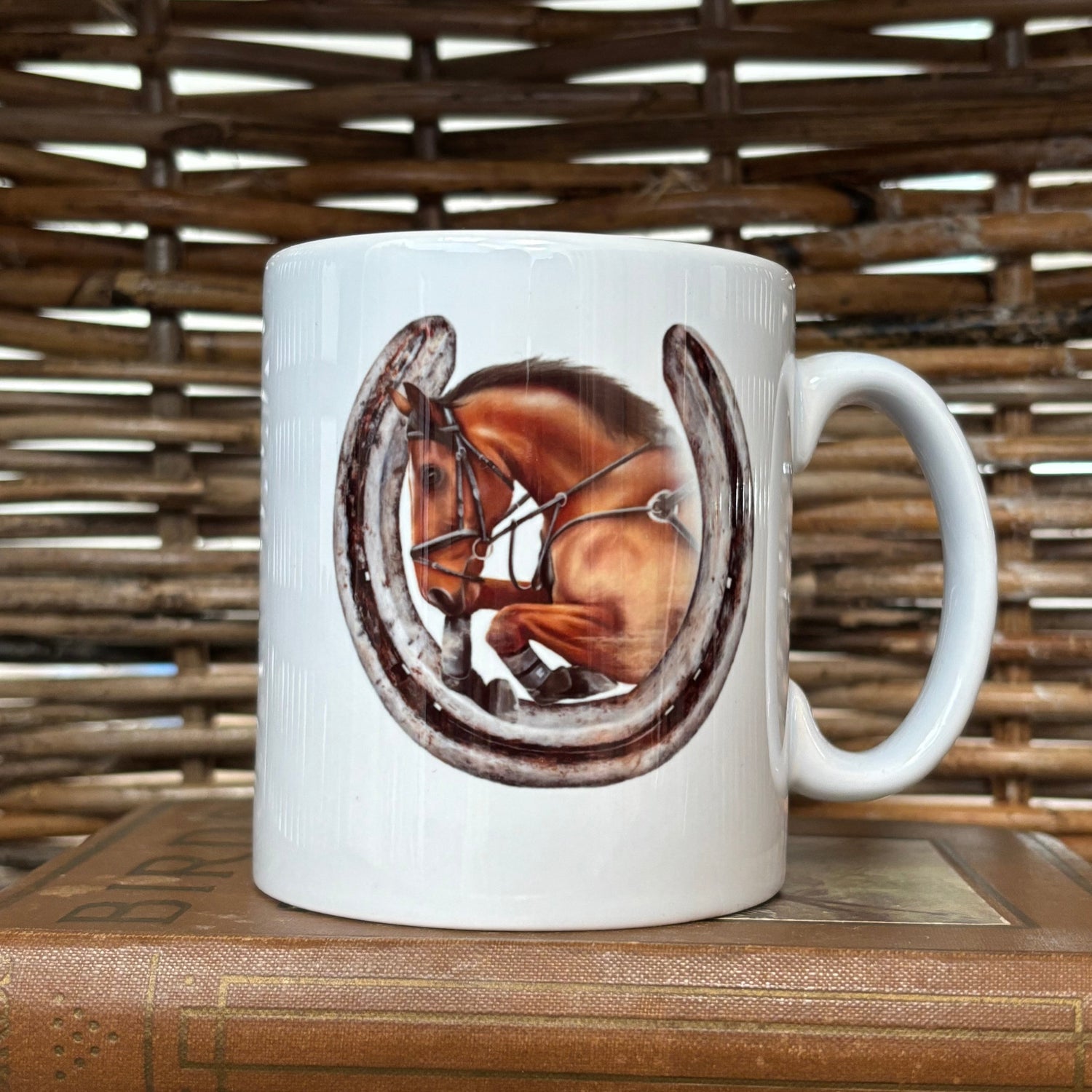 White mug with a horse design on a wooden surface