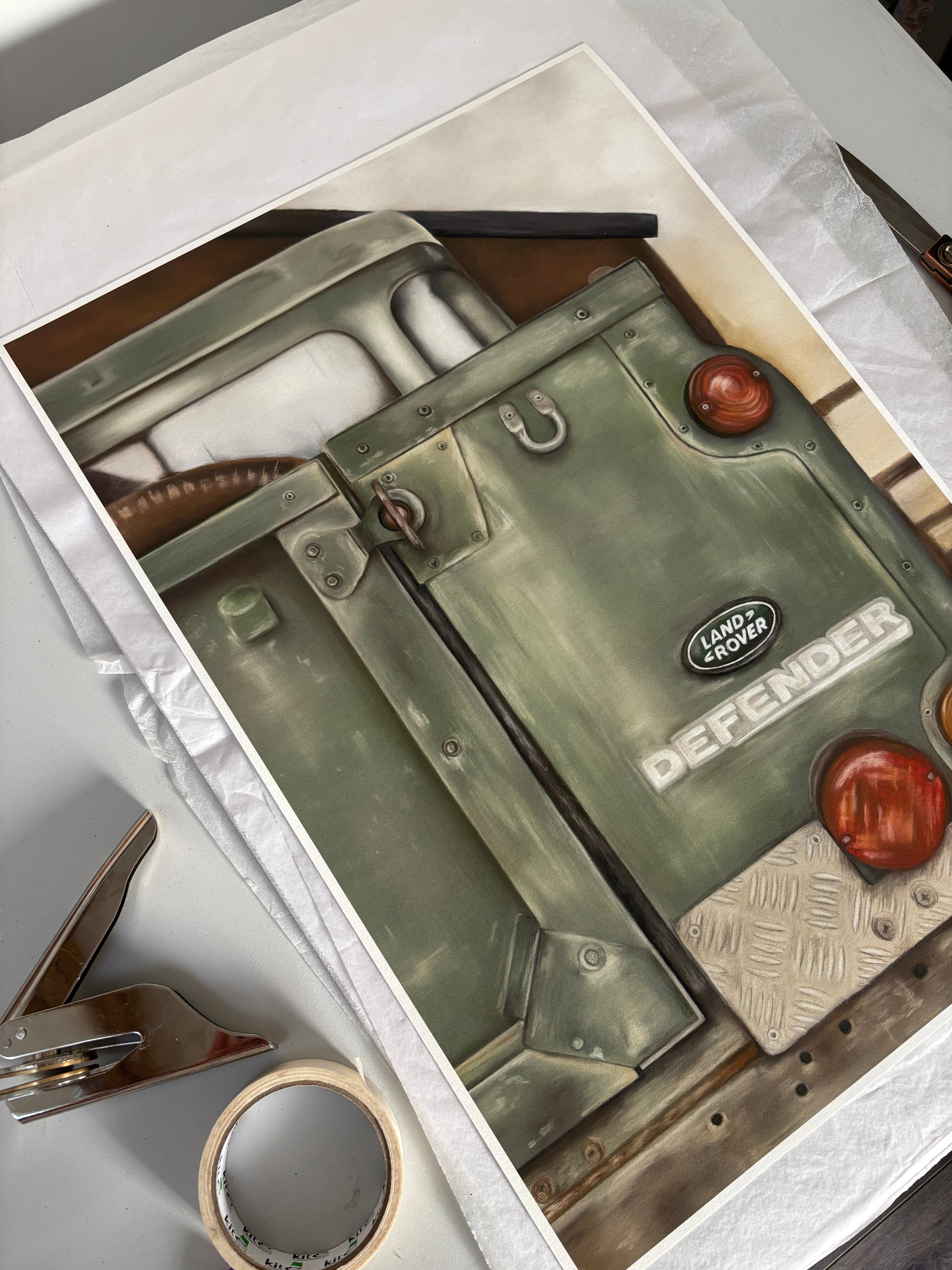 Unframed Landrover Print - Art Print | British Classic, Limited Edition on a table with packaging tools. High-quality countryside wall art ready for framing.