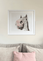 Country home decor featuring 'Nosy Pony' original horse artwork by Georgie Turner, framed and mounted above a soft-toned couch. Great for equestrian art collectors.