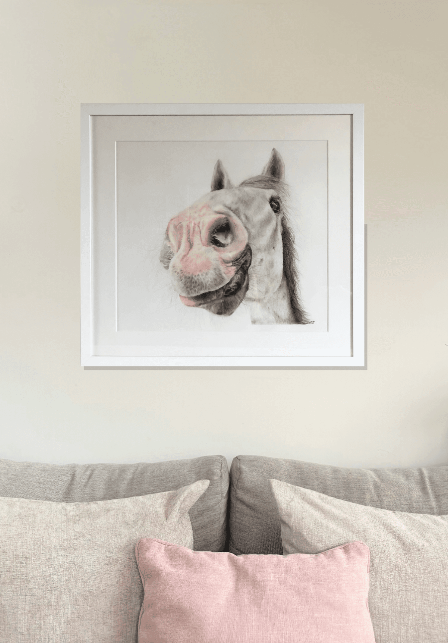 Country home decor featuring 'Nosy Pony' original horse artwork by Georgie Turner, framed and mounted above a soft-toned couch. Great for equestrian art collectors.