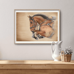 Framed Showjumping Fine Art Print On Paper showing a dynamic horse in motion, placed on a wooden surface with rustic home decor accents.